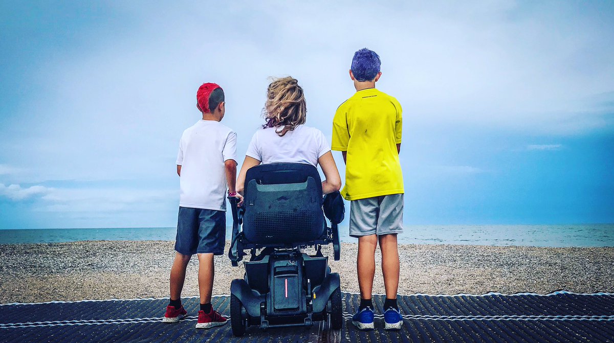 The first time my boys have ever been to the beach with their momma in a wheelchair. 😊💜 — with @MyCOFB