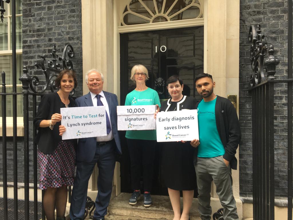 bowelcanceruk's tweet photo. Day three of our week of action! We're at 10 Downing Street with 10,000 signatures asking the UK government to commit to #LynchSyndrome testing for all bowel cancer patients and their families. A huge thank you everyone supporting our #TimetoTest campaign. https://t.co/he1pgRnjBE https://t.co/XQxjuyFLK2