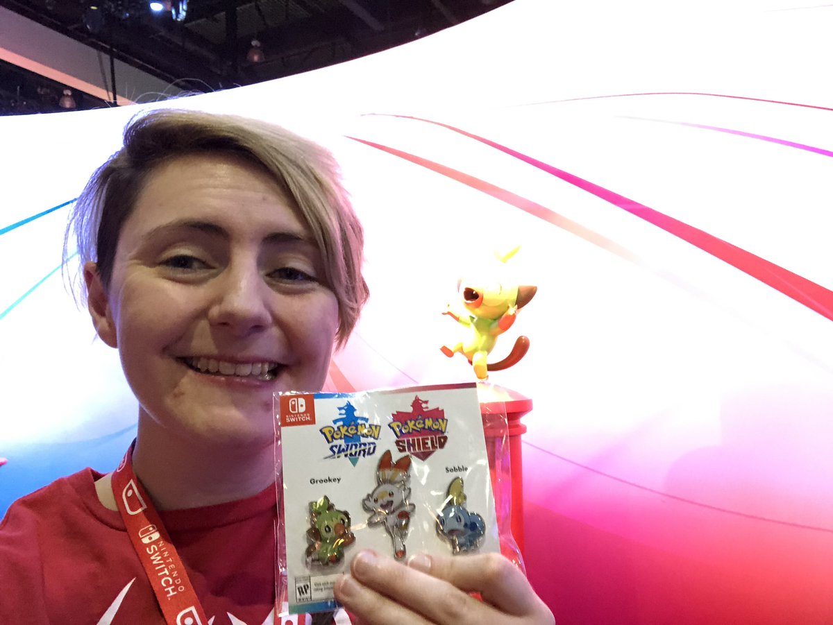 Me holding up some pokemon pins!