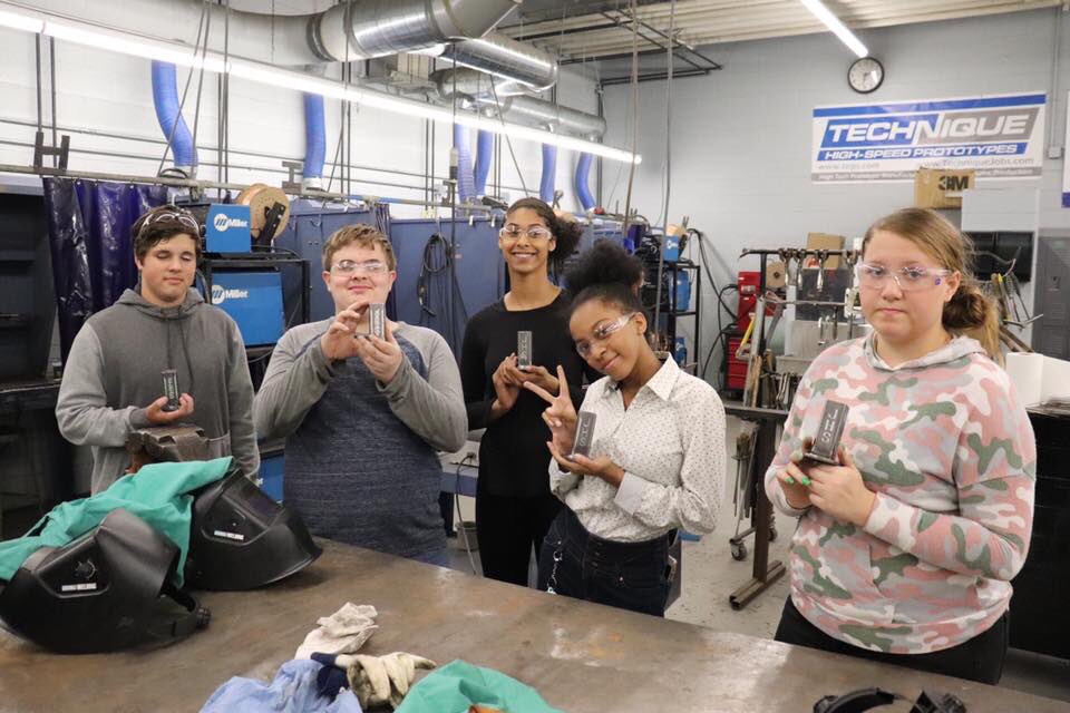 JaxCareerCenter's tweet photo. This group could be the next generation of engineers, machinists &amp; welders! A select group of JHS sophomores spent the day learning about Manufacturing careers - starting w/tours at local manufacturers &amp; ending with a project - an engraved pencil holder - they made from scratch! https://t.co/1ee0gfh9Co