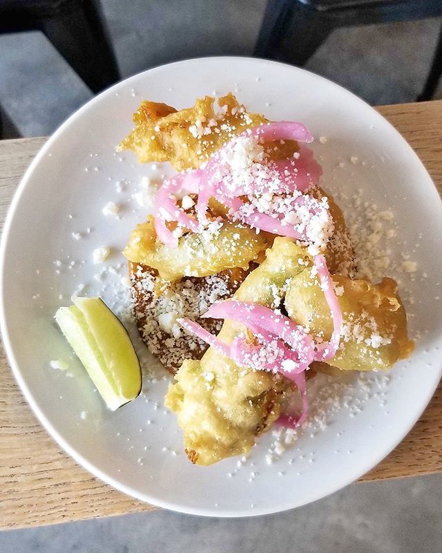 A summer fave! ☀️ Squash three ways! KSA-tempura squash blossom stuffed with squash, crispy summer squash, pumpkin seed mole, cotija, and lots of pickles! Come try it soon at Black Sands! bit.ly/2wR7vAg