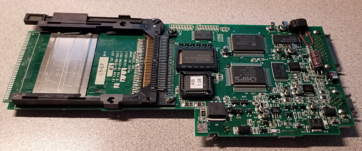 And here's the underside.There's a PCMCIA slot, and some assorted chips, and a microphone in some plastic/foam that's turned into sticky glue.