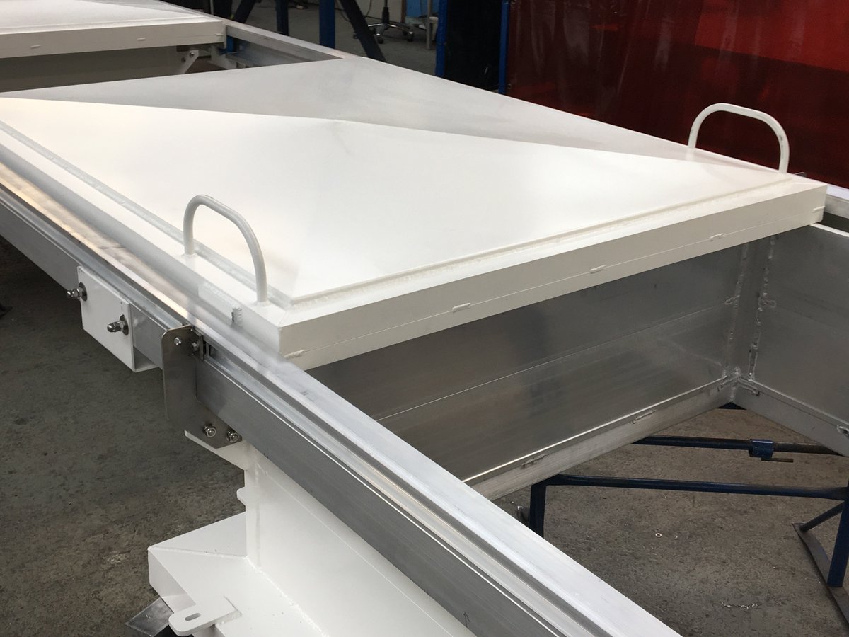 UnitechEngr's tweet photo. New sliding hatch covers for a salmon rearing barge ready for despatch. Check out the video @ https://t.co/RFQMH5XBMW 
#salmon rearing, #sliding hatches, #salmon farming https://t.co/67nq4naCVz