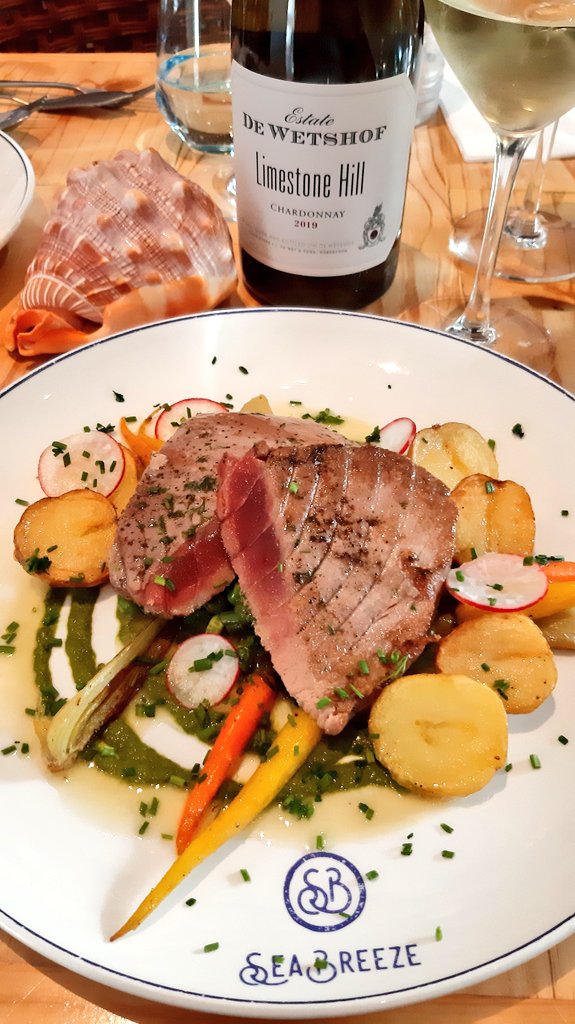 WittyWineWoman's tweet photo. First two courses out at @seabreezeCT today as we celebrate the @dewetshofestate Limestone Hill Chardonnay 2019.
I'm in heaven right now. A fantastic prawn salad and perfectly seared tuna! 😀
#LimestoneHill2019 #LimestoneHill https://t.co/ylm93sTX4N