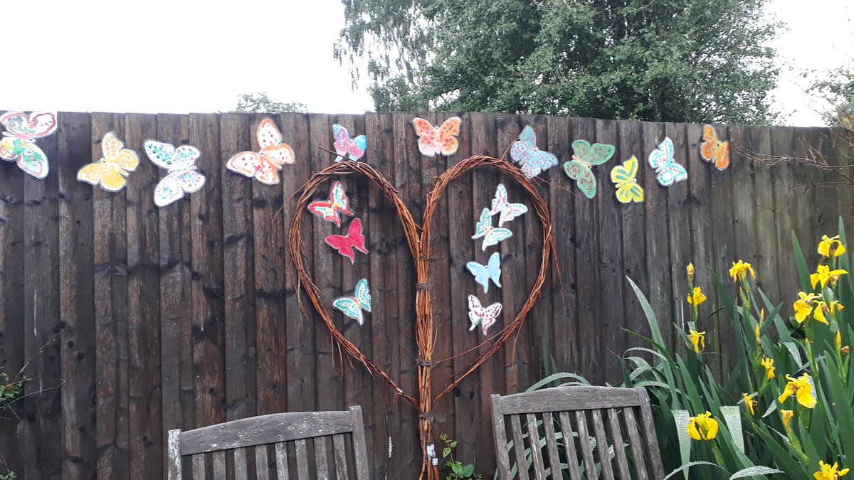 DerbyMojo's tweet photo. Colourful butterflies now laminated and decorating a dark fence in the garden at Aspen Court. The rest will be displayed in Devon on the Tree of Celebration #creativemojoderby #artforall #dementiaaware #nationaltrust #knighteshayescourt #treeofcelebration #Butterflies https://t.co/FpcYQ5DHcJ