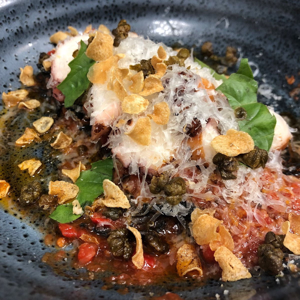 Fresh and delicious -- Our Grilled Octopus, squid ink tajarin, piperade, basil, and crispy capers. #dinealysbeach #calizarestaurant