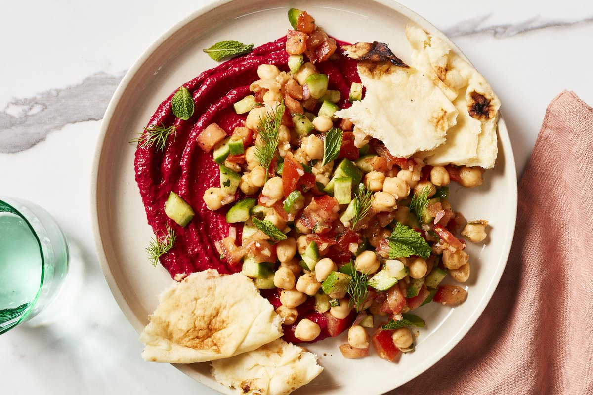 Beets make a beautiful comeback in this Shirazi salad where they give lend a pink hue to yogurt and roasted garlic spread: bit.ly/2I9AcNX