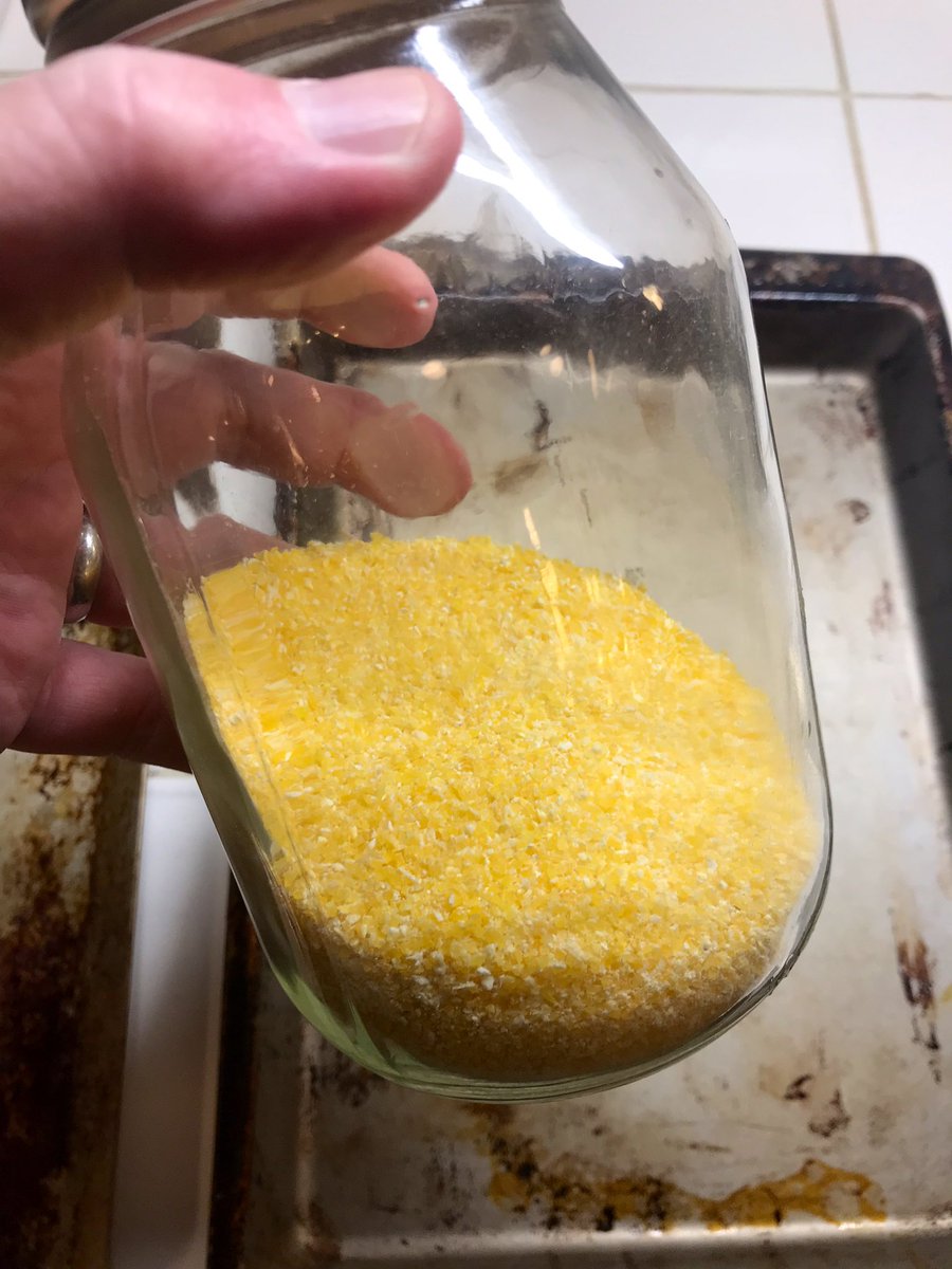 Ok! The dough has doubled in size. Let’s get some cornmeal (or flour) and dust the bottom of a baking sheet.