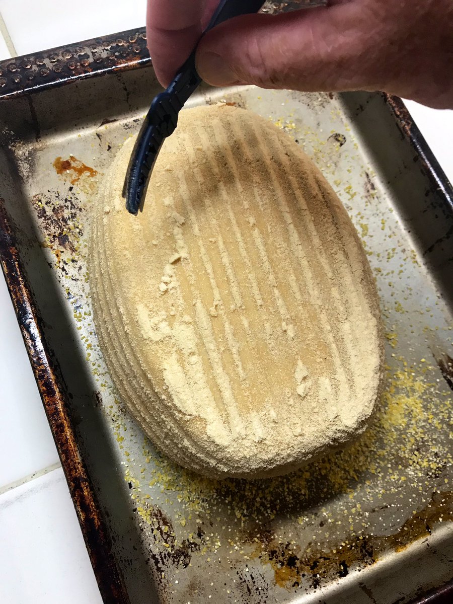 CAREFULLY turn the basket or bowl onto the baking sheet. The last step before popping it into the oven is to SCORE the top of the dough, as an expansion joint so that when the loaf expands it doesn’t split or warp. To do that we use a razor blade, but anything sharp will do.