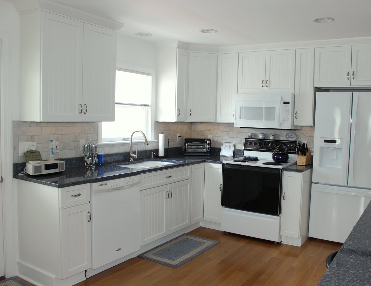 CoolidgeCompany's tweet photo. The color palette of the beach sand and ocean waters are carried inside to the kitchen with the white bead board cabinets and deep blue stone countertops. (Hampton Beach, NH) #kitchenrenovation #beachhouse #interiordesign https://t.co/P6s0fexcOa