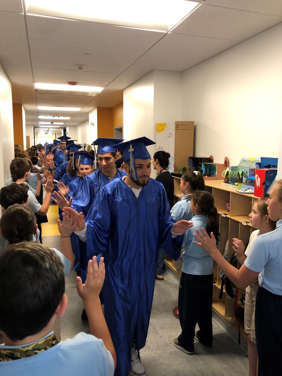ACS_Tritons's tweet photo. The Class of 2019 got a warm sendoff, complete with cheers and high fives, as they paraded through the halls of Atlantis in their caps and gowns for the last time before graduation on #FallRiverCollegeDay2019. #EdUp https://t.co/W9jK1sd3kF
