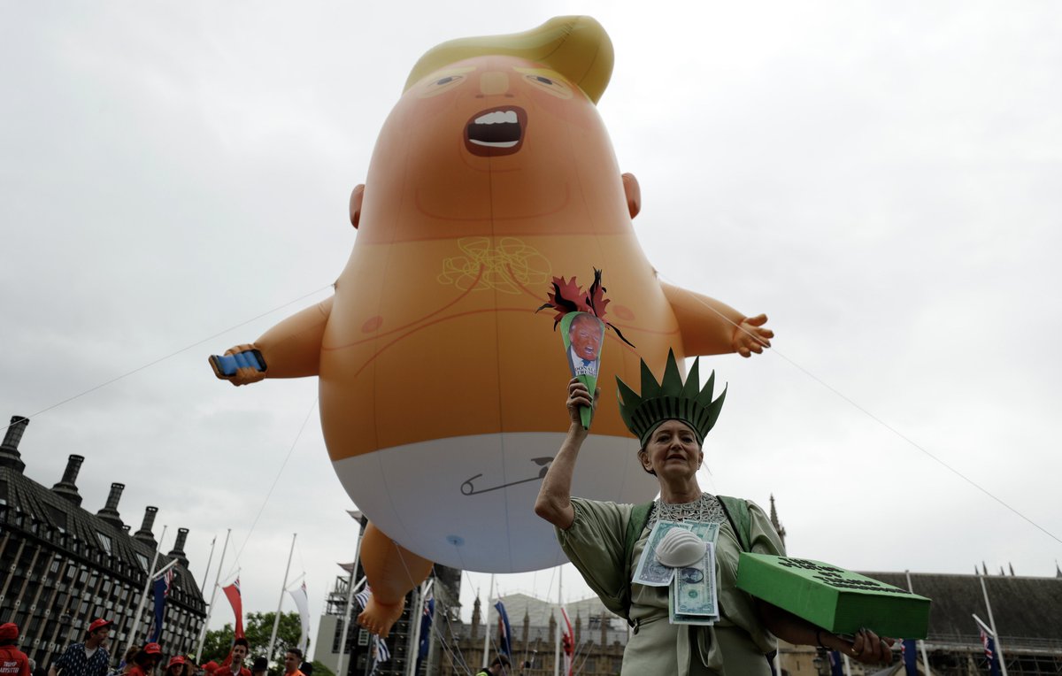 ajplus's tweet photo. Thousands of UK protesters demonstrated against President Trump.

A flying baby blimp rose from Parliament Square. Elsewhere, a "Dumping Trump" robot sat on a golden toilet, phone in hand. https://t.co/s38w2awF35