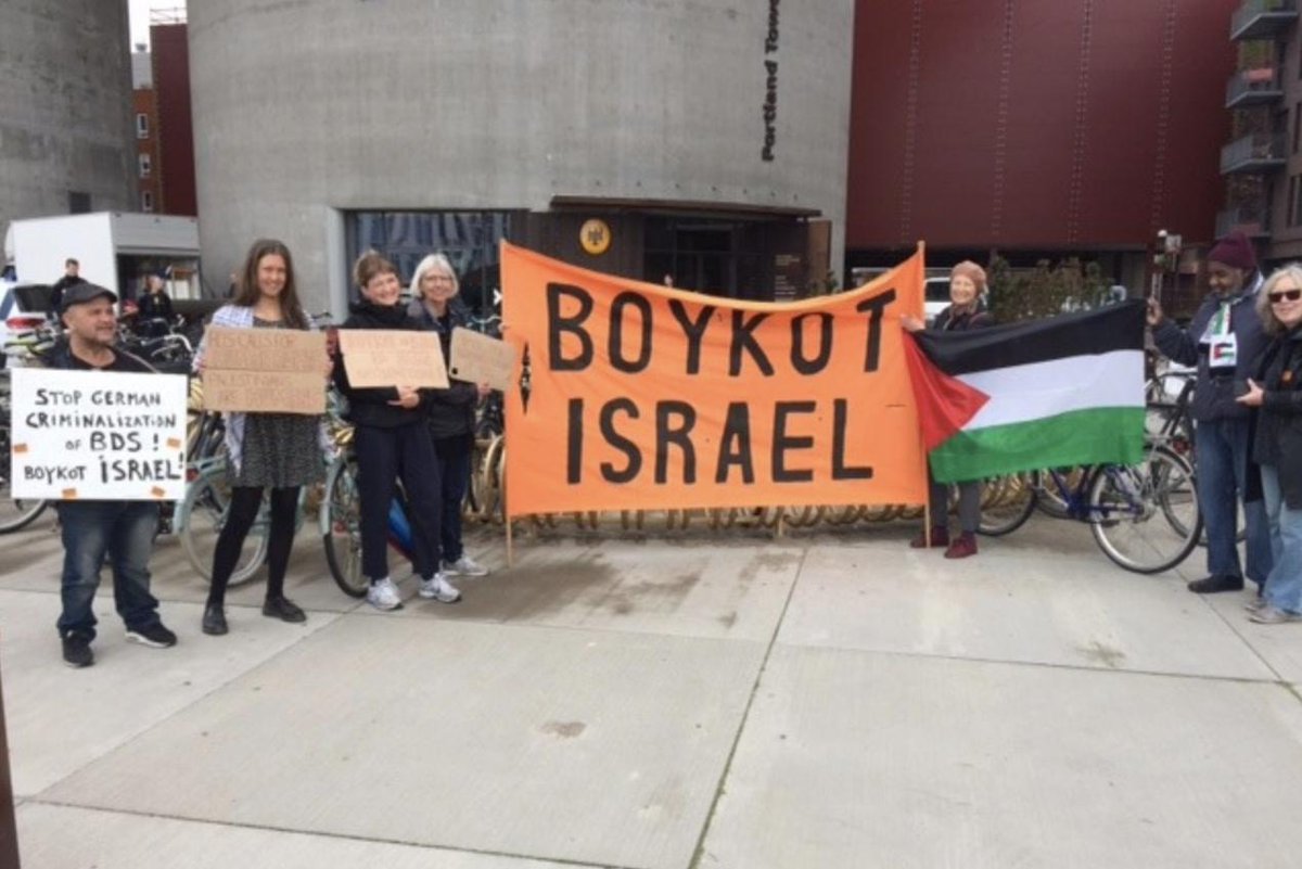 BDSmovement's tweet photo. Human rights activists from Boycott Israel-DK rallied last week at Germany’s Copenhagen embassy. 

They delivered a letter criticizing the German Parliament attack on BDS &amp; affirming #BDS is an anti-racist movement that opposes Israel’s apartheid policies: https://t.co/iznlX8nTMF https://t.co/6dozDTzGwI