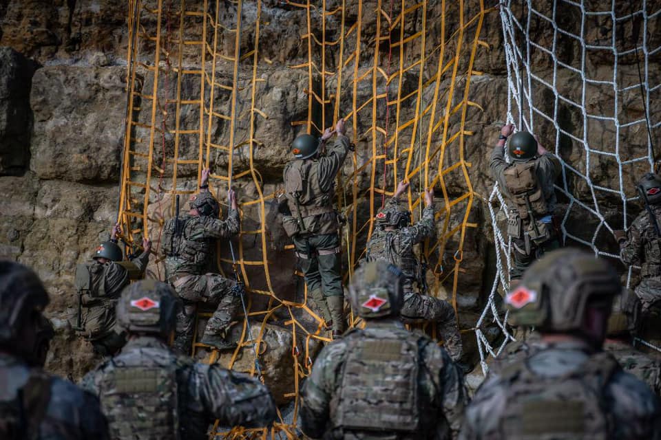 DeptofWar's tweet photo. Following in the footsteps of heroes. @USArmy soldiers climb the historical cliff face at Pointe du Hoc on the northwestern coast of Normandy, France. 75 years ago, soldiers tackled this same cliff and seized the German artillery during the #DDay invasion. #HonorThem #DDay75 https://t.co/oGHmGq1TiL