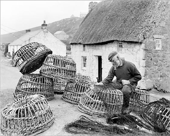 "Is it worth mending?". #ThrowbackThursday to Bill Harvey inspecting fishing nets surrounded by lobster pots in front of a thatched cottage at Porthgwarra in June 1903. Photographer: Herbert Hughes or John Charles Burrow. Available at: ow.ly/31Q130ogq8J