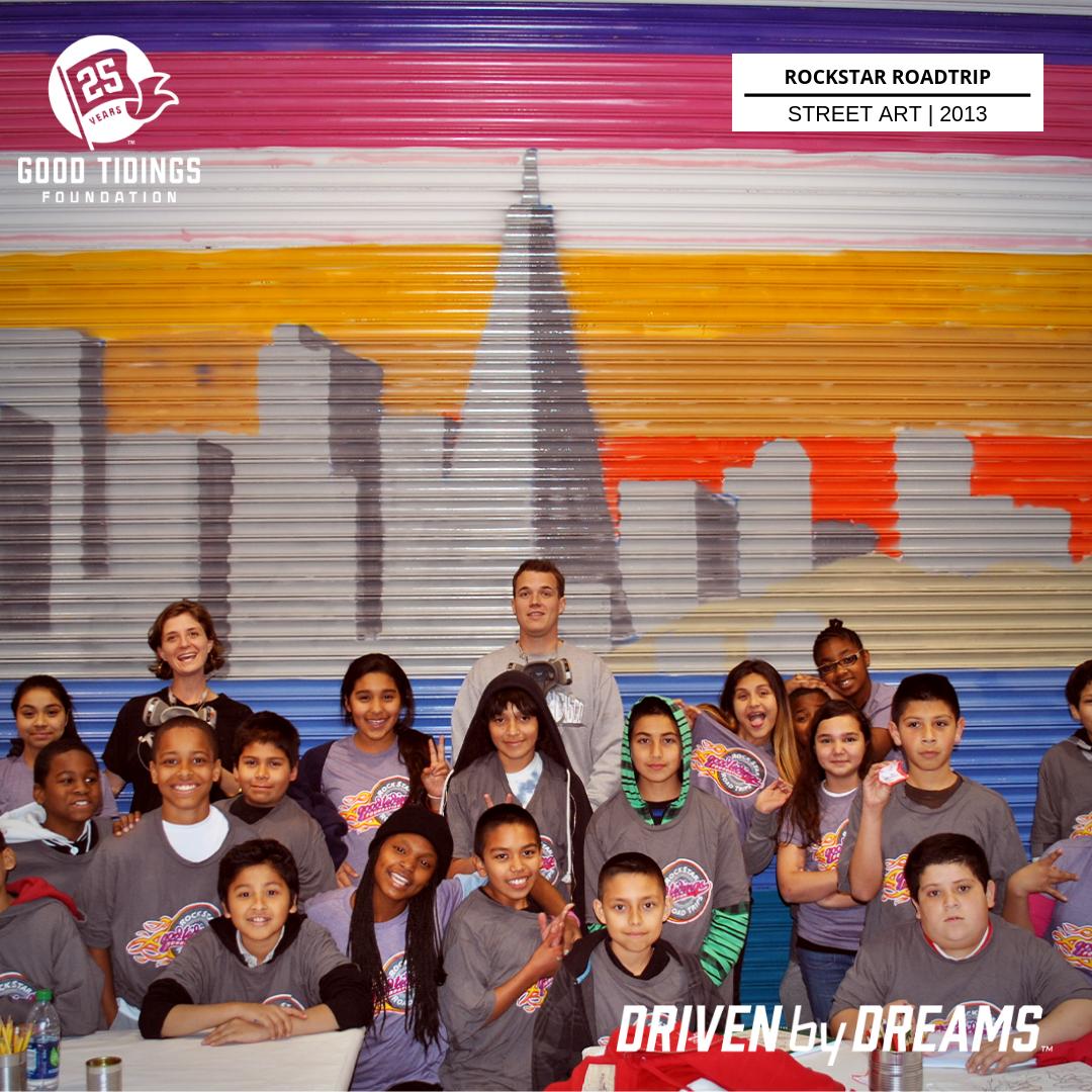 goodtidingsSF's tweet photo. #TBT - In 2013, Bay Area street artist, Jurne and Magz taught a group of students the history and beauty of legal street art and murals. The student spent the day making over the LeRoy Neiman Art center bay door with the beautiful mural of the San Francisco skyline.  #25YearsofGT https://t.co/fFklrl1Jdc