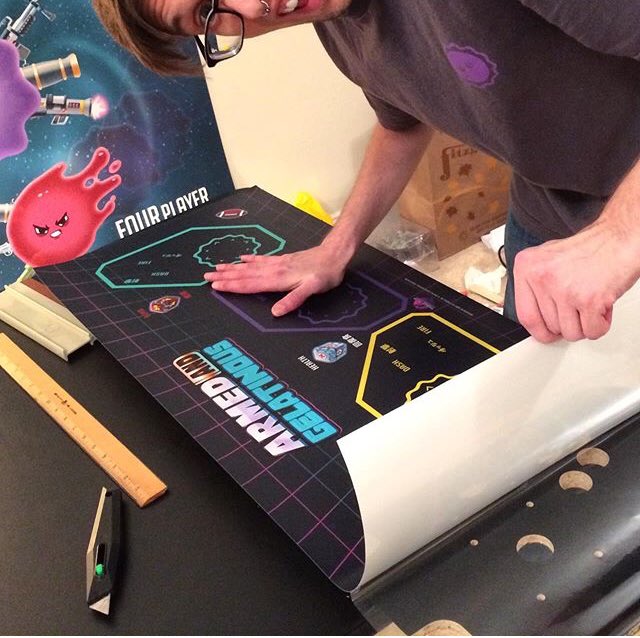 Slowly but surely applying the control panel graphic to the melamine. The button holes have to line up perfectly! #arcade #diy #vintage #indiegame #videogames #retro #retrogames #woodworking #indiegames #videogame #👾