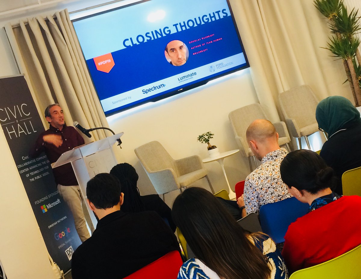 CivicHall's tweet photo. #PDF19 live: "This PDF was smaller, and in that way it became local and real." "Can we undo the threats created by digital tech?" "Democracy is not a noun but a verb." And other closing thoughts by @rushkoff as he sums up the day's themes. #civictech #makingtechcivic https://t.co/FLGtxGLgCw