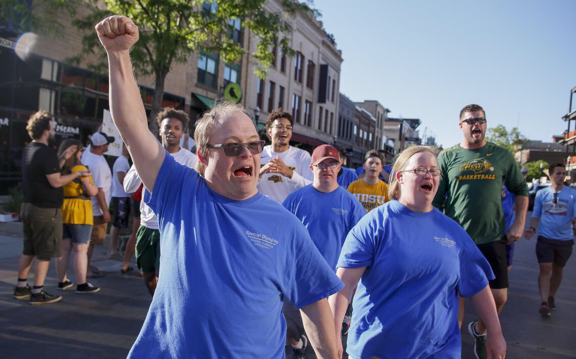 SwanyND's tweet photo. Great night for North Dakota Special Olympics! Helping lead the athletes in the march on Broadway and to Opening Ceremonies? Mr. Energy himself @KyanBrown and the @NDSUmbb team! Fun pic in the @inforum! https://t.co/ziEw9Mmyki