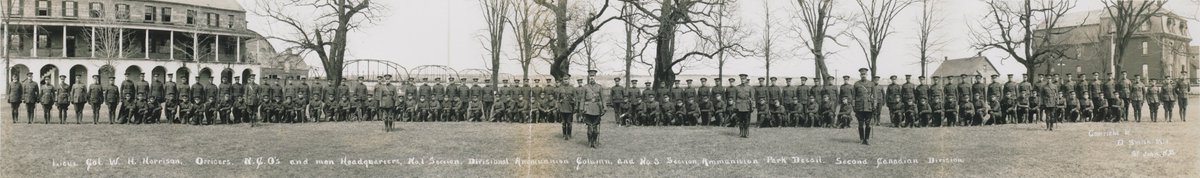 Jeandron's tweet photo. A recent photo of Officers' Square with historic Lemont House (1880) & cropped section of a pano of Officers & Men of the Headquarters, #1 Section, Divisional Ammo Column superimposed, from a 1915 pic prior to their departure to Europe for WW1. Lest we forget. #SaveOfficersSquare https://t.co/eY7su06UMQ