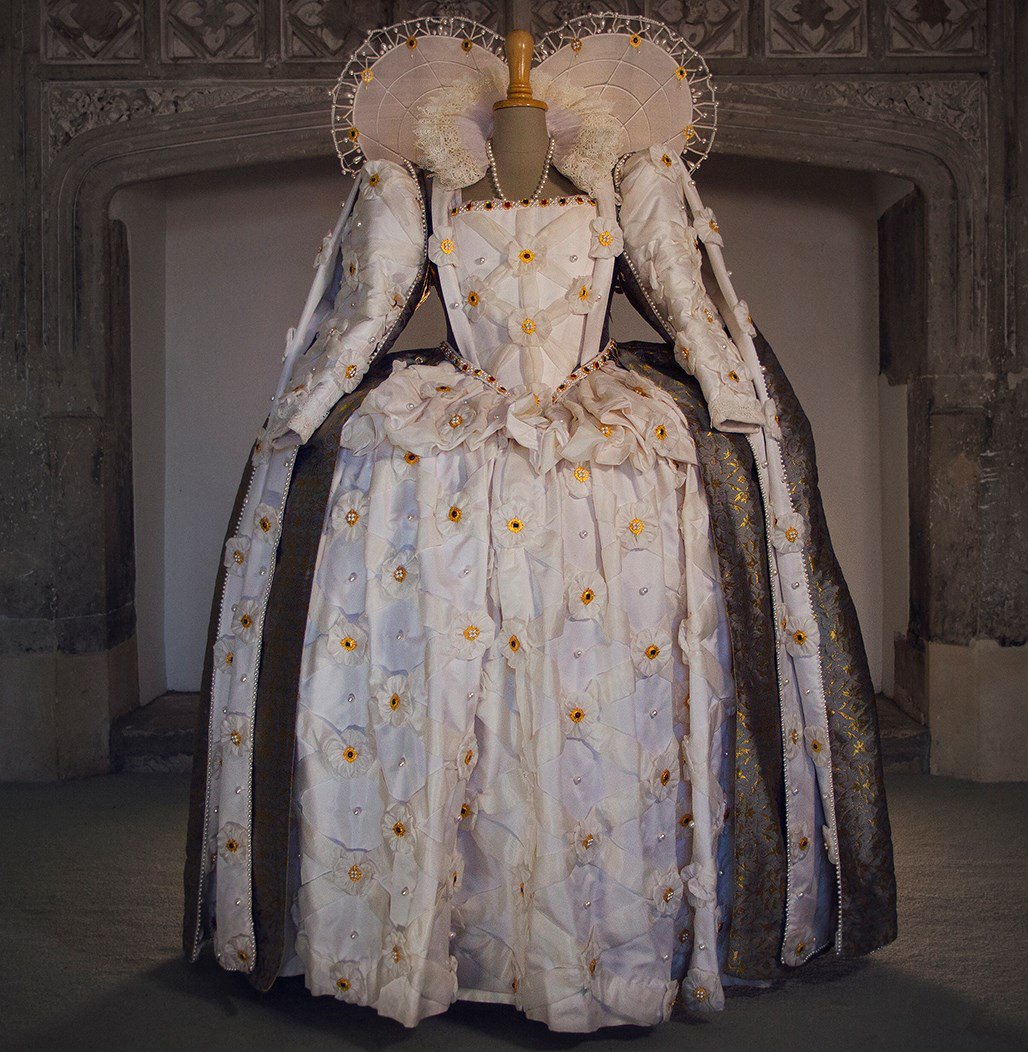 In the famous Ditchley portrait of Elizabeth I, the Queen stands in a gown  of white silk, woven with silver. This dress is an accurate recreation,  created by Past Pleasures. Our free
