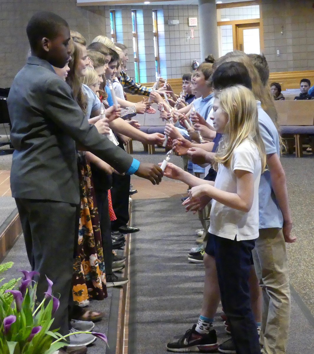 Photo of the Week: Passing of the light from last week's Fifth-Grade Graduation. Congratulations, students -- have a great summer and enjoy middle school in the fall. God bless you!
