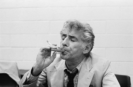 NormalComposers's tweet photo. Leonard Bernstein smoking a cigarette while playing a kazoo. https://t.co/HYEA6EPLET
