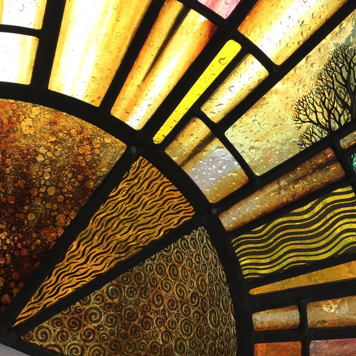 Some nice rainy photos of my ‘sunrise’ panel.it will be heading up to Dumfries after #RHSChatsworth. #stainedglass #moon #sun #reddeer #stag #sunrise