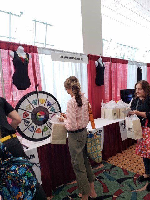 FireMtnGems's tweet photo. We're having a blast at the #beadandbuttonshow! Our prize wheel is a big hit! 
#insidefiremtn #wisconsincenter https://t.co/3JwDwJwFDs