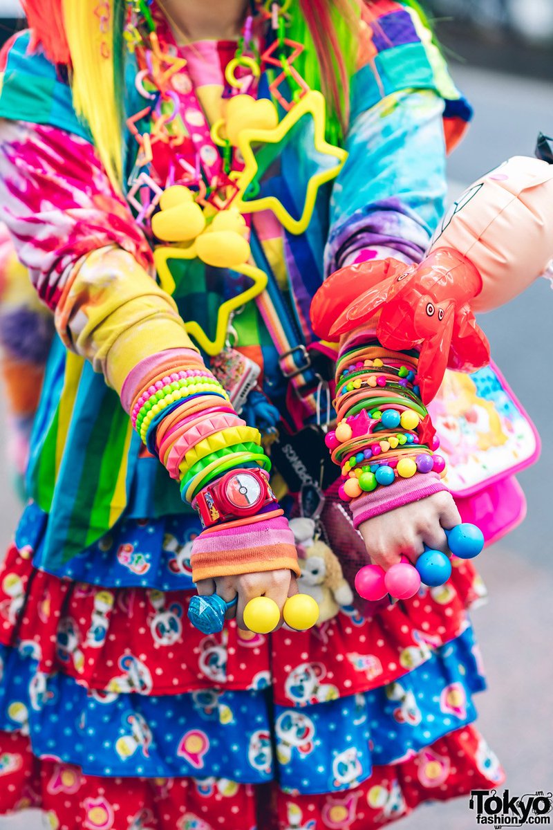 Well known Harajuku personality Mai on the street wearing a handmade old school decora look w/ rainbow hair, a flip phone, a Tomoe Shinohara doll, furry leg warmers, Care Bears, Sailor Moon, Pokemon & lots of colorful decora accessories #原宿 tokyofashion.com/rainbow-decora…