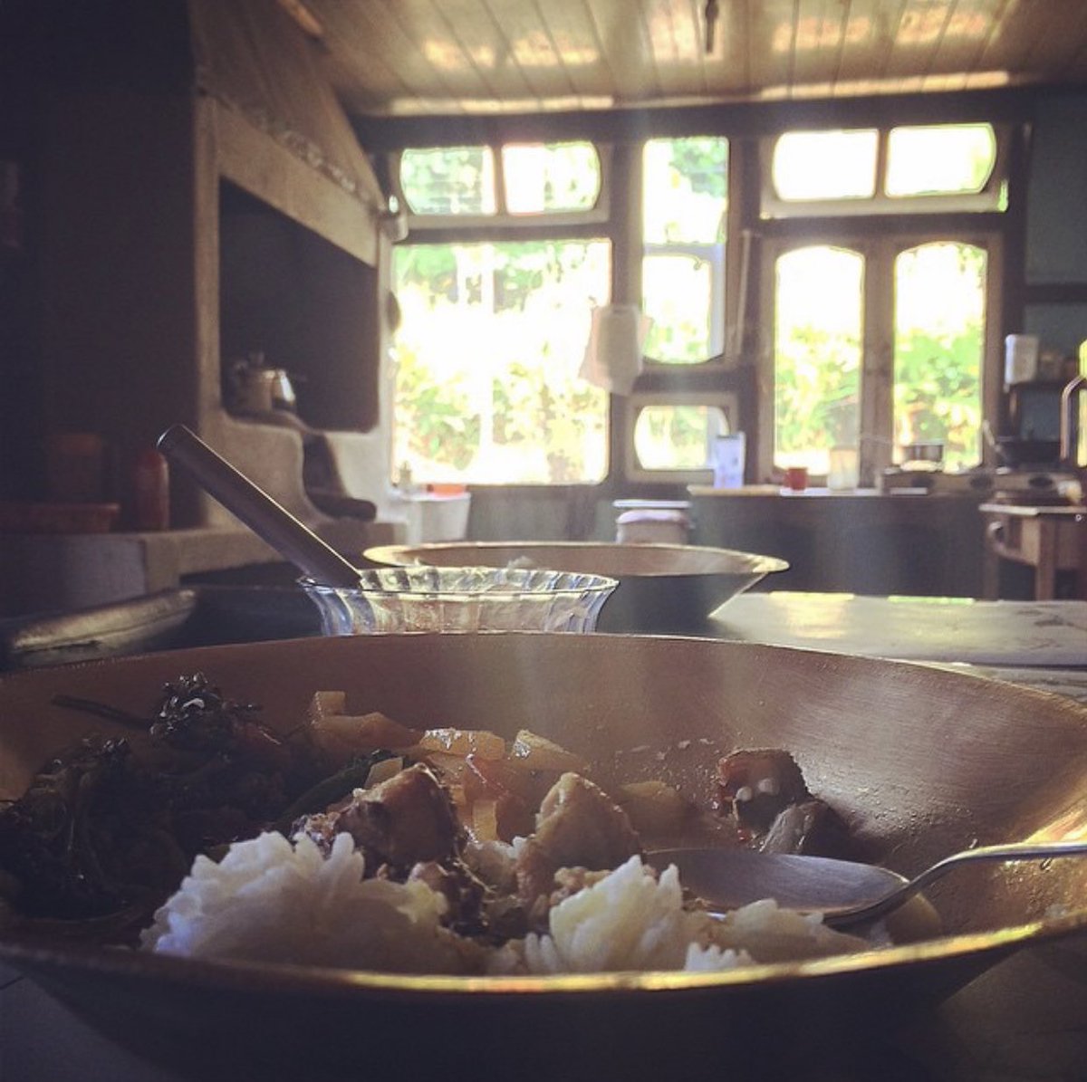 Old pic is a beautiful kitchen in rural Sikkim. Kansa bartans rule the roost here as well. On the left is the raised wood-fire choolah, you can see where the log of wood goes in. Underneath this is an area to store the wood.