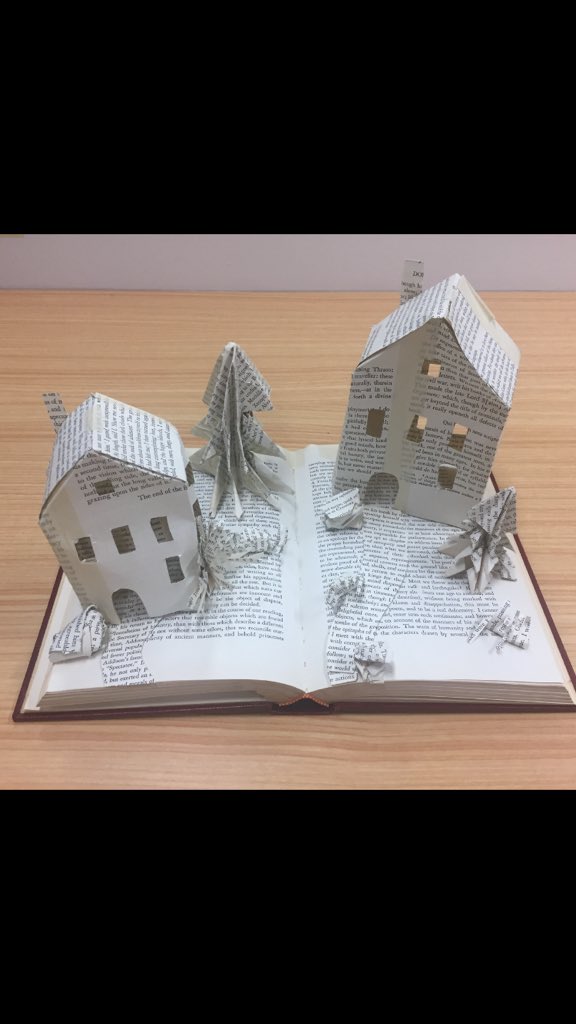 Librarycat6's tweet image. Library displays are so much easier to put together when clever staff whip up crafty little numbers like this one! This book art village made a great addition to our winter display. What is your favourite display to create? #SwinLibStudents #librarydisplay #bookart