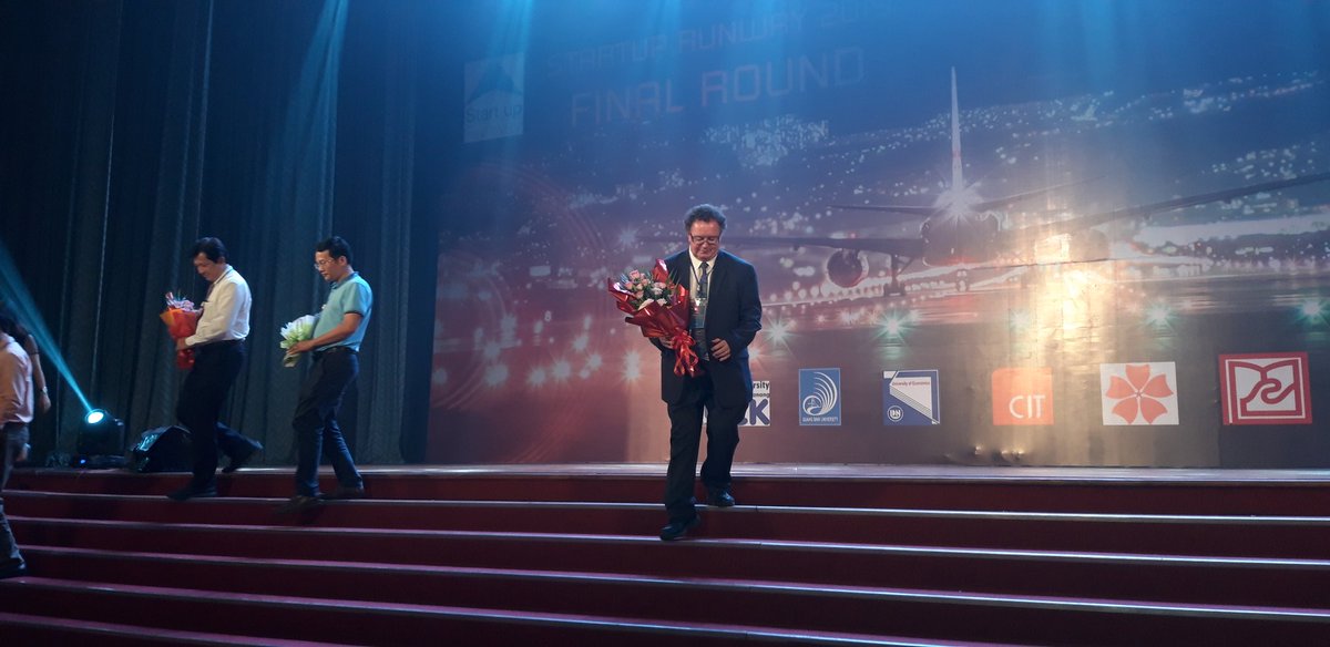 GeorgeBulman's tweet photo. The great #GerKelly receiving his flowers award at the final of the #irishaidvietnam VIBE competition in Danang. @GeorgeBulman @hamcguirk @rubiconcentre @HincksCentre @OrlaFlynnCIT @CIT_ie https://t.co/1pUjATXQYP