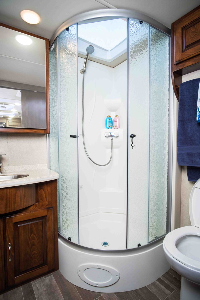 Regency_RV's tweet photo. This large, radius, hammered-glass shower with dual slide doors features two shampoo shelves and a handheld spray head. The large skylight above brings the outside in, yet has a privacy shade.
#UltraBrougham #RegencyRV #LivinginFirstClass https://t.co/m5Y00D3pF5