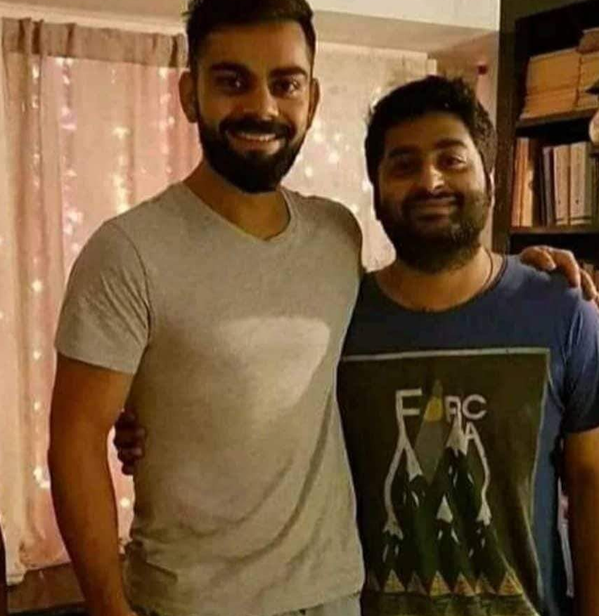 SoupyLel's tweet photo. I thought Mohammad Shahzad had gone back to Afghanistan? Here he is, posing with Kohli! https://t.co/cnp5NL3L9p