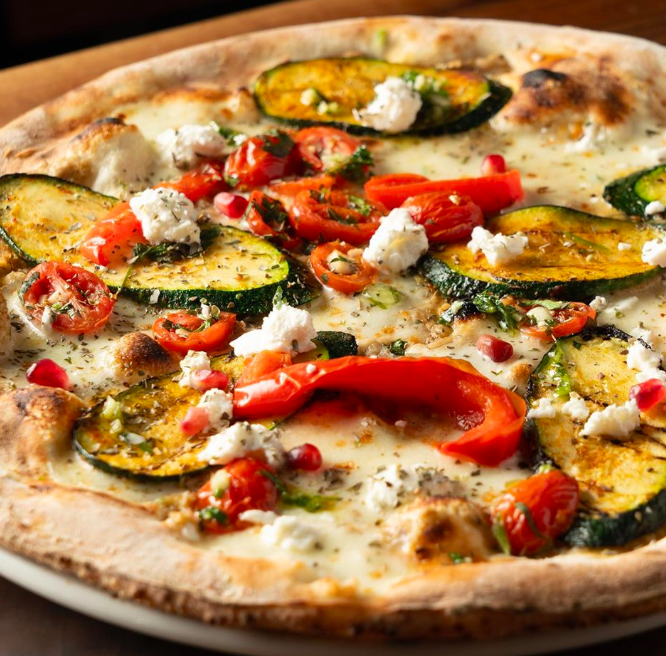 Meet Adonis, a handcrafted vegetarian wood fired pizza with smoked eggplant, fior di latte, peppers, zucchini, tomatoes, feta, pomegranate, citrus gremolata &amp; oregano 😋

#goraptors