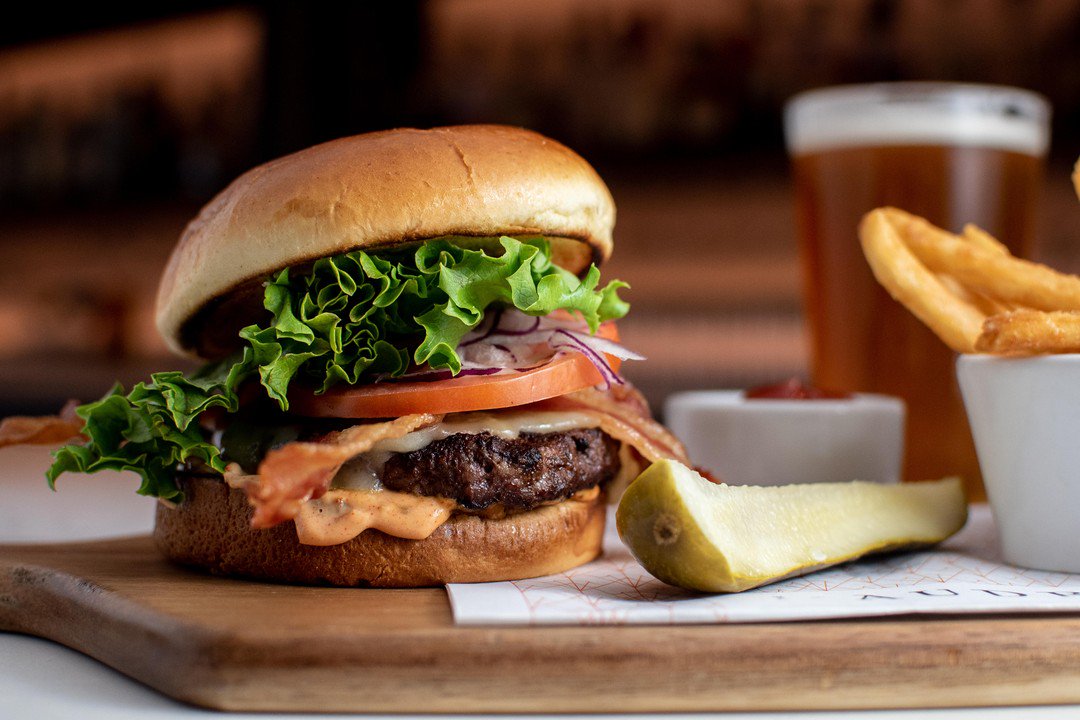 Have you heard? It's #MadisonBurgerWeek! Stop by The Audrey to try a new favorite in town. The Audrey Burger is one of our most popular items! A premium beef patty, topped with lettuce, tomato, 2-year aged cheddar and our own special sauce! 😋 The best way to describe it is yumm!