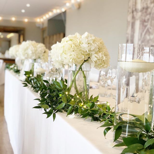 Give your top table the wow factor with foliage, blowsy hydrangeas and candlelight.
.
TOP TIP: It’s important to not have anything too high on a long top table. You and your guests will want to see each other! 💖
.
#Venuestylist #yorkshireweddings #ve… bit.ly/31P2bvs