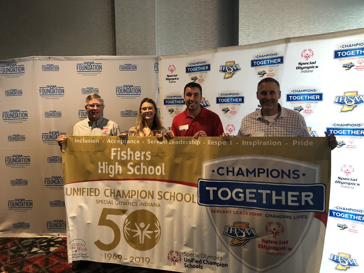 Lauren Grater, Evan Barker, Mr. Brown and Mr. Urban display the Special Olympics Indiana 50th Anniversary Gold Banner presented to 36 schools. They were also recognized as one of twelve schools honored for six years as a Unified Champion School.