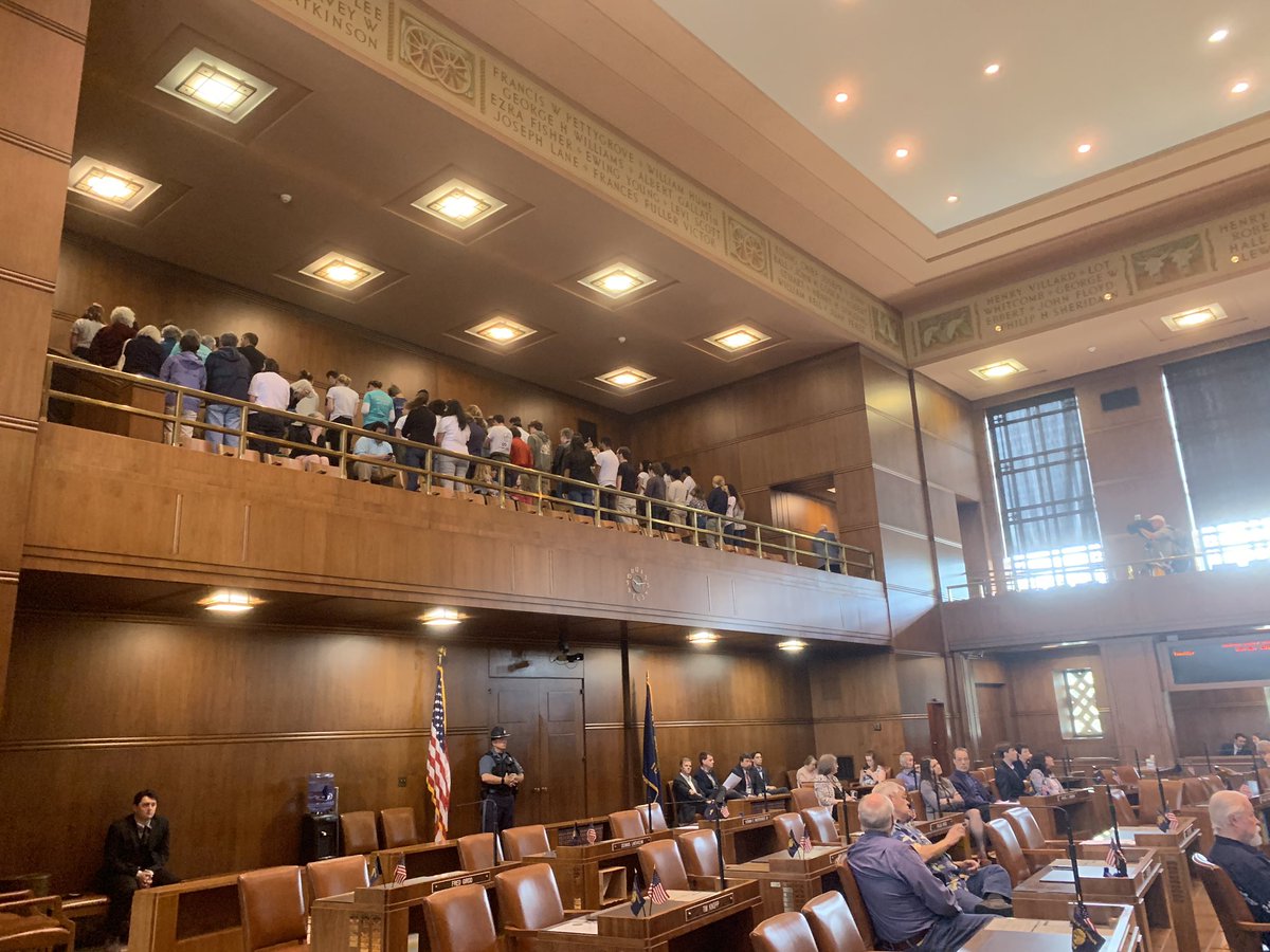 LaurenDake's tweet photo. Young climate activists in the Senate gallery get up and turn their backs as Sen. Courtney announces the cap-and-trade bill is likely dead. #orleg https://t.co/eR7Wmq0VTW