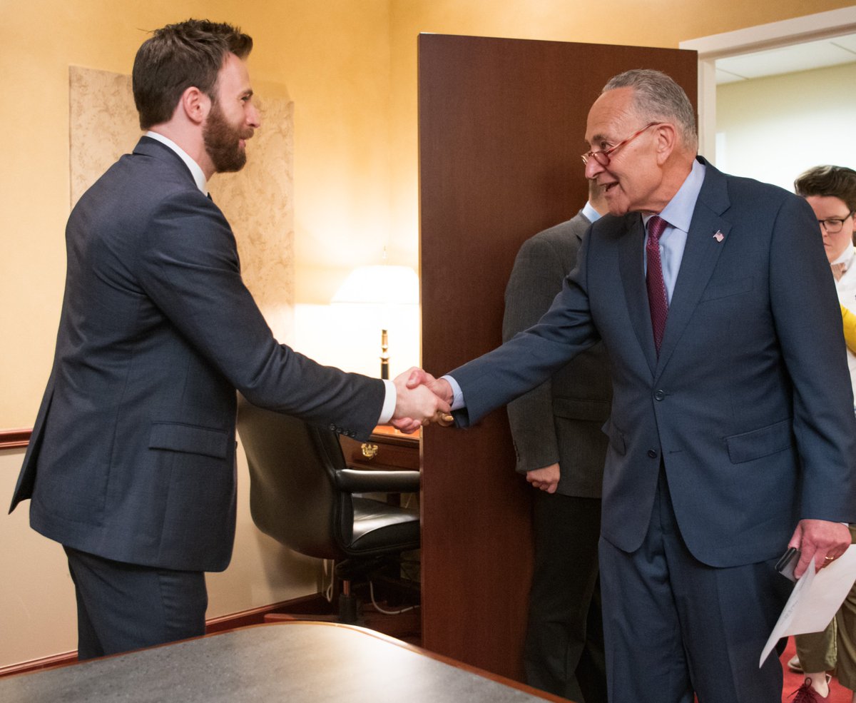 Senator Schumer shakes hands with actor Chris Evans.