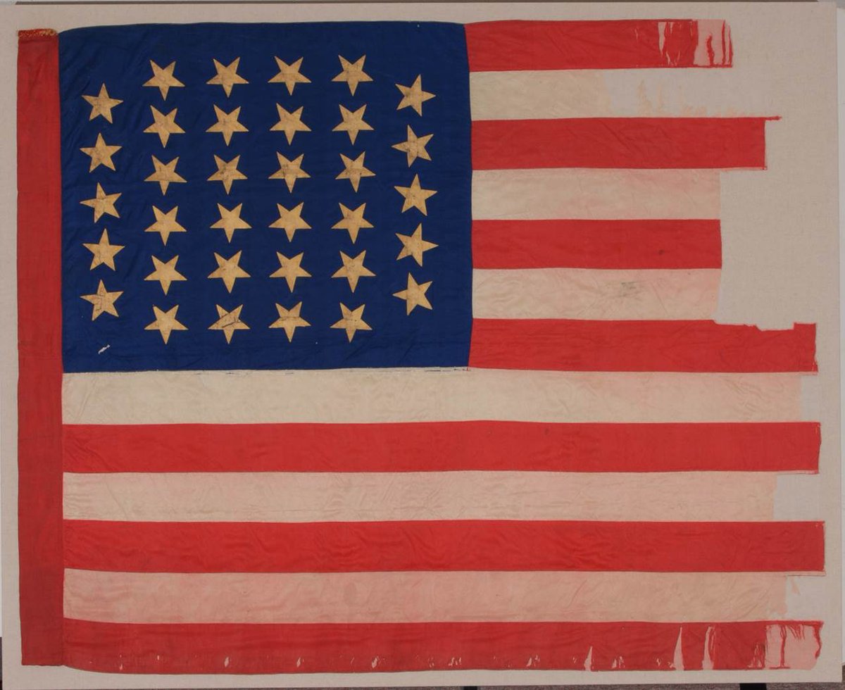 ILStateMuseum's tweet photo. Happy #FlagDay! This flag was carried in the Civil War by the 33rd Illinois Infantry and likely made by their wives and daughters. The damage on the right side of the flag is from individuals later cutting swaths of the flag for souvenirs. #StoryofIllinois #ILStateMuseum https://t.co/hd28zfKPf7