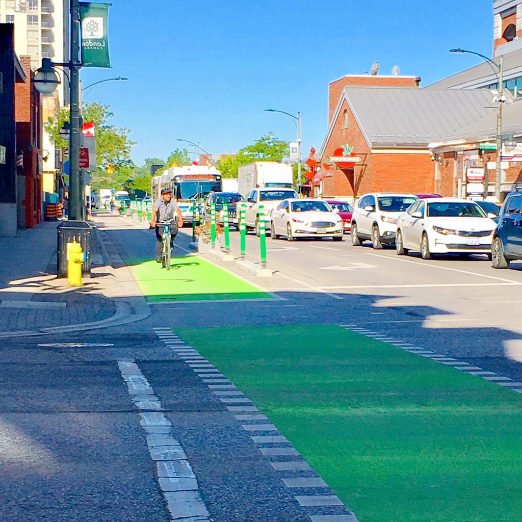 GreenEconomyLDN's tweet photo. Happy FriYAY! We’re celebrating by admiring the beauty of the (brand new!) bike lane on King Street! @LdnOntBikeLane @CityofLdnOnt #bike2work #Ldnont https://t.co/aeXRE5ye66