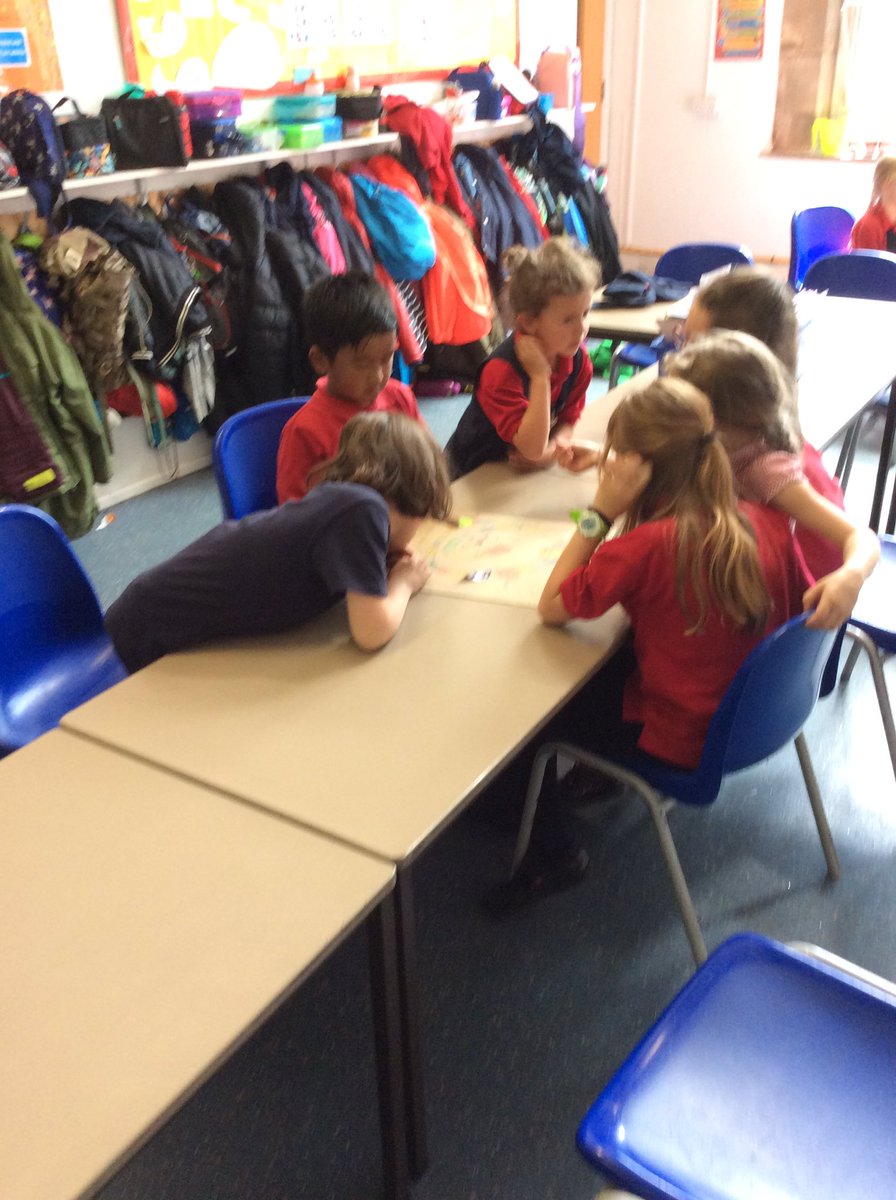 Elm Class playing their handmade plant based board games with their Year 1 reading partners