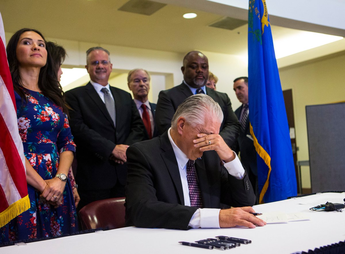 CSStevensphoto's tweet photo. Nevada Gov. @SteveSisolak pauses before signing a trio of bills, including #AB291, a comprehensive gun safety bill, alongside Oct. 1 survivor and Assemblywoman @sandra4nv and Speaker @JasonFrierson, at the Sawyer Building in Las Vegas https://t.co/BGKTYYAhrb
