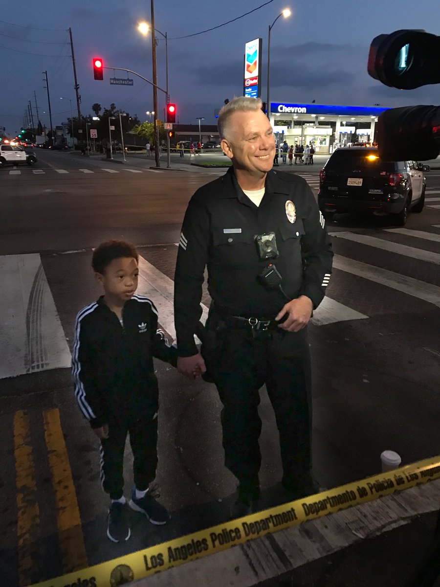 PaceVideo's tweet photo. Before LAPD Sgt. Tim Jones talked to the media, he saw a young boy interested, took his hand and brought him across the police line as he spoke. Later he spent 20 minutes talking to young people. #LAPD #policeofficer #police #communitypolice #SouthLA #tvnews #KTLA #losangeles https://t.co/CfXNUGq6je