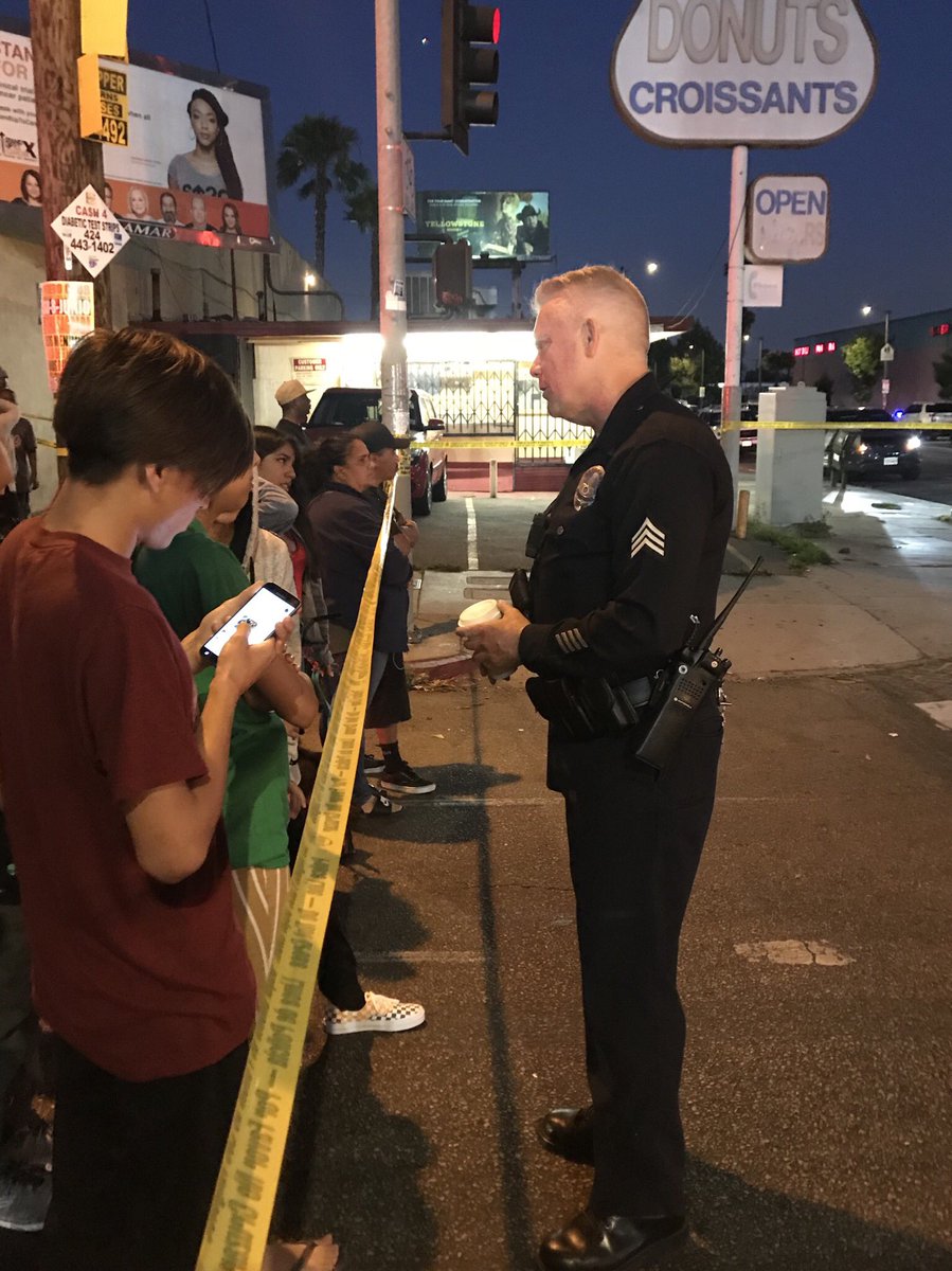 PaceVideo's tweet photo. Before LAPD Sgt. Tim Jones talked to the media, he saw a young boy interested, took his hand and brought him across the police line as he spoke. Later he spent 20 minutes talking to young people. #LAPD #policeofficer #police #communitypolice #SouthLA #tvnews #KTLA #losangeles https://t.co/CfXNUGq6je