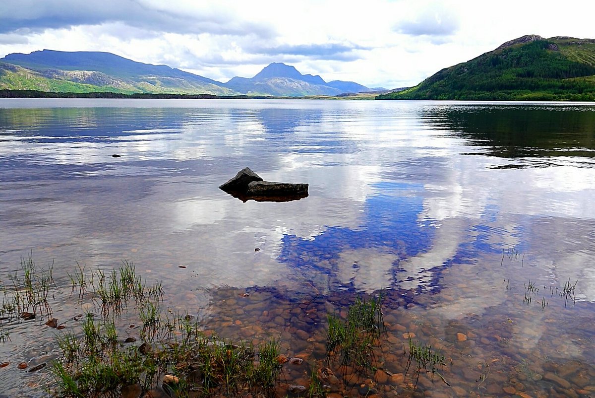 A half-submerged rock in Loch Maree hoping to be a #mountain one day, like Slioch in the distance! #Scotland