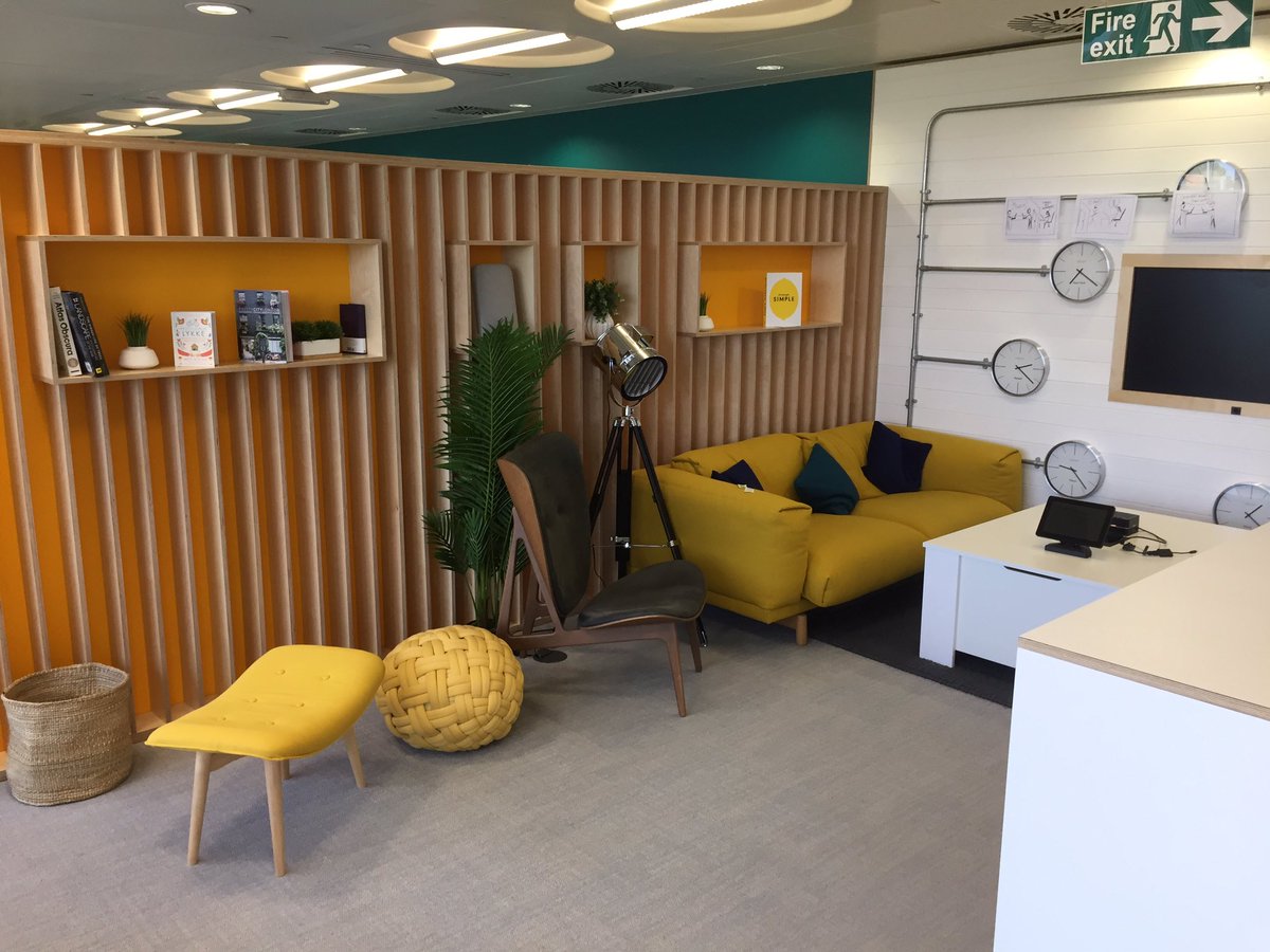 Google breakout space with sofas, digital screen and bookshelves