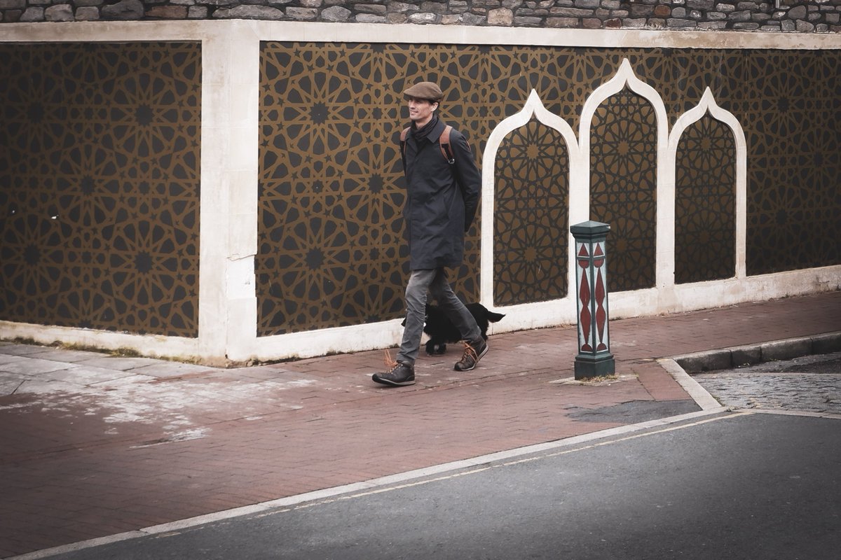 Man walks dog past the Easton Jamia Mosque on St Mark's Road, Bristol. This road is a finalist in the 2020 Urbanism Awards' 'Great Street' category, (and it is indeed a great street). #WexMondays #fsprintmonday #sharemondays2019 #fujifilm #UrbanismAwards